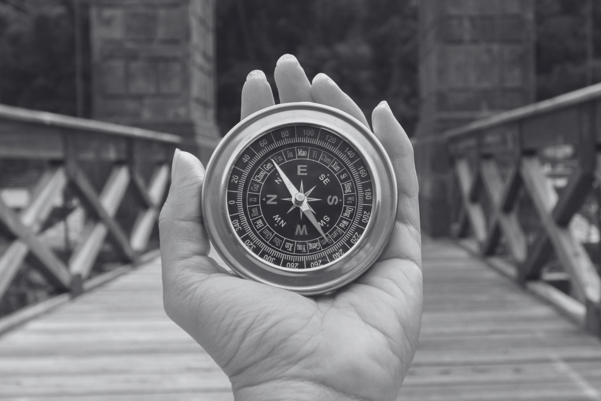 A woman holding a navigating compass
