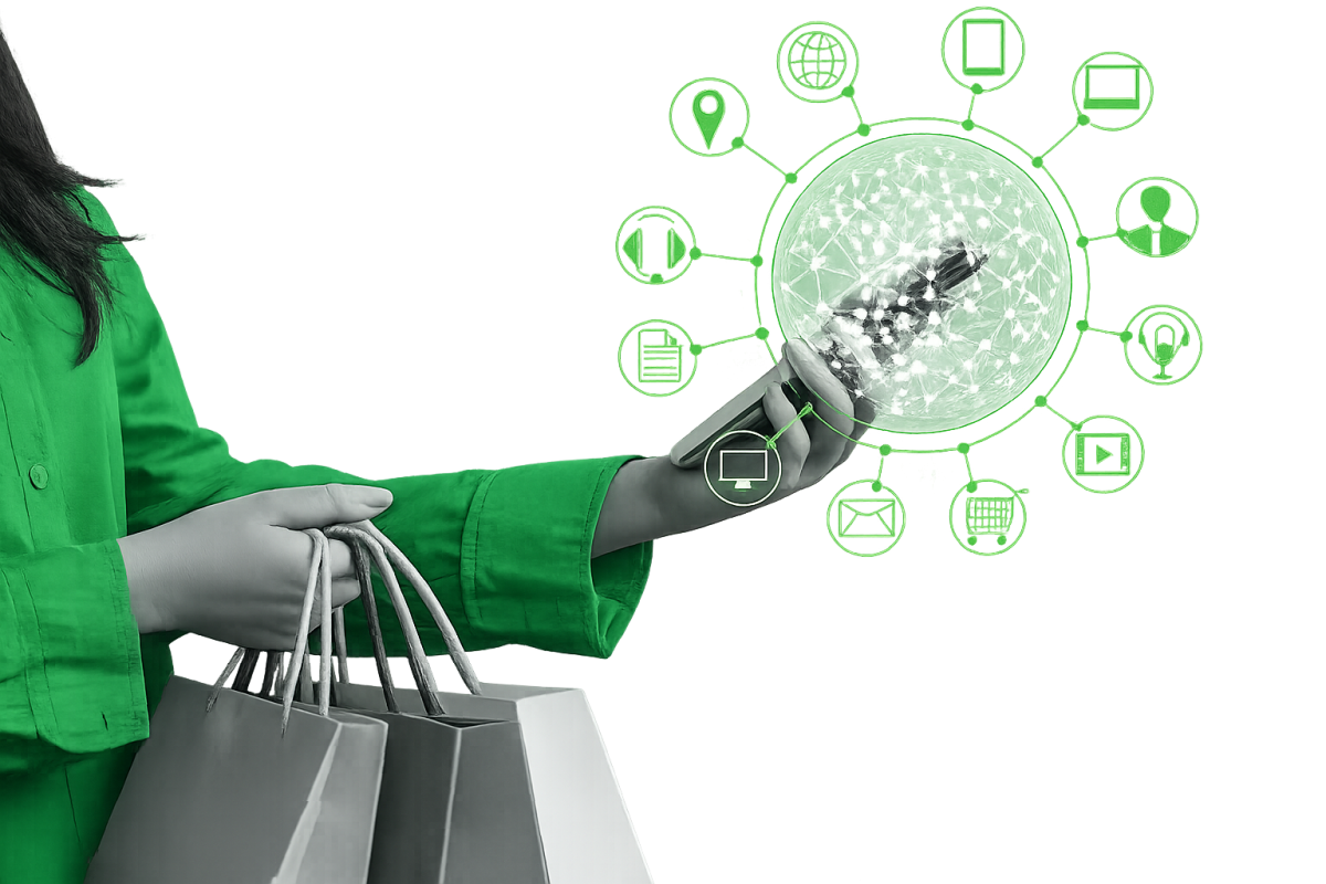 Person in a bright green shirt holding shopping bags in one hand and a smartphone in the other, with grayscale digital commerce icons floating around the phone against a transparent background.