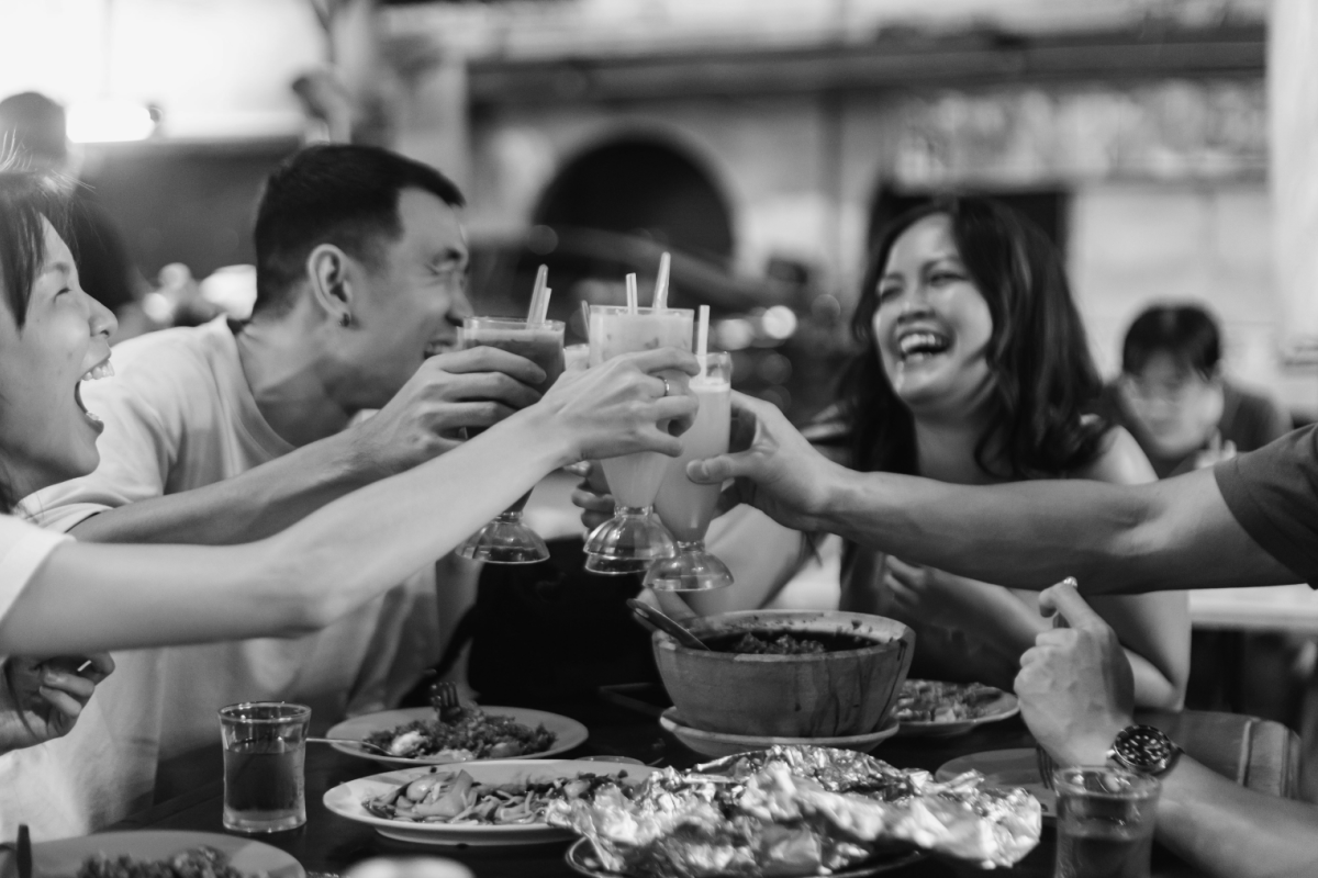 People having fun in groups and holding drinks for the party